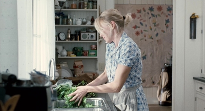 a woman is preparing food in a kitchen