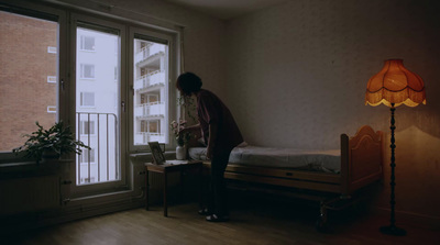 a woman standing in front of a window in a room