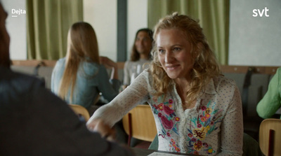 a woman is shaking hands with another woman at a table