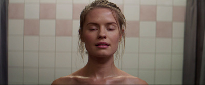 a woman in a shower with her eyes closed