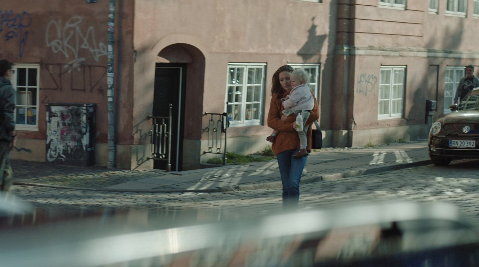 a woman with a child walking down a street