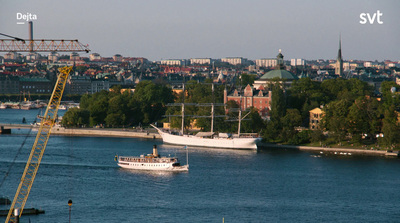 a boat is in the water near a city