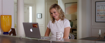 a woman sitting at a desk with a laptop in front of her