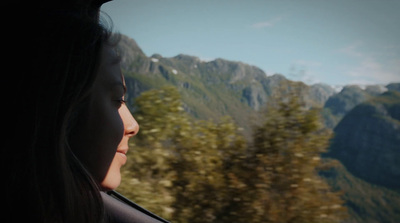 a woman looking out the window of a train