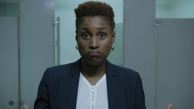 a woman in a suit standing in a bathroom