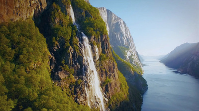 an aerial view of a waterfall in the mountains