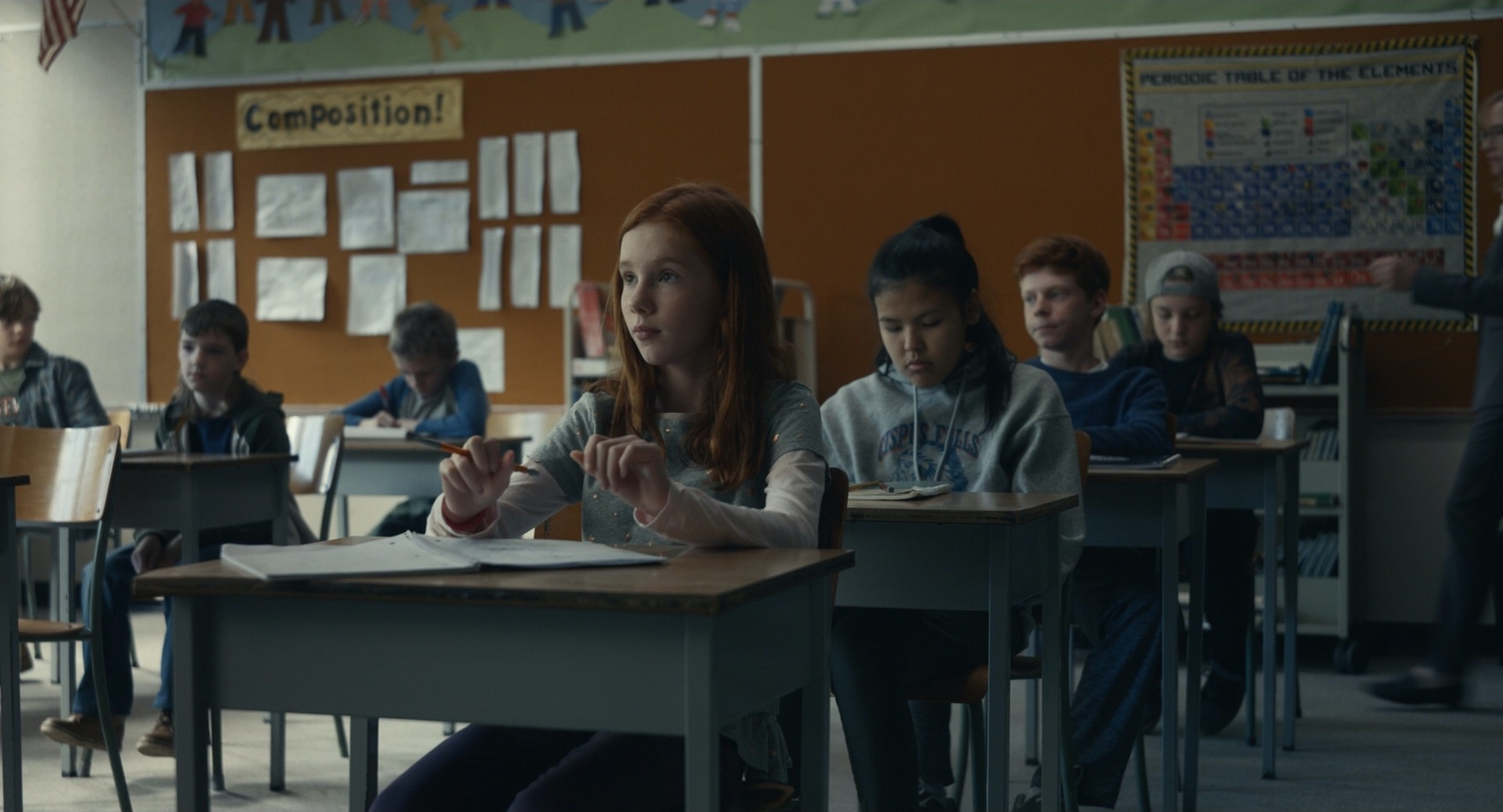 a group of children sitting at desks in a classroom