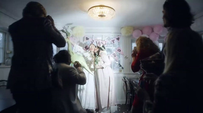 a group of people standing in a room with balloons