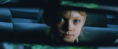 a young girl is seen in the rear view mirror of a car