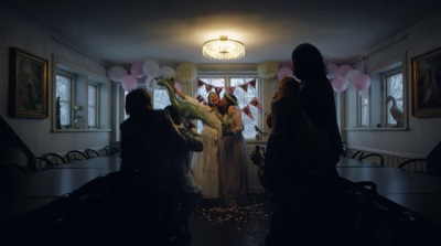 a group of people standing in a room with balloons