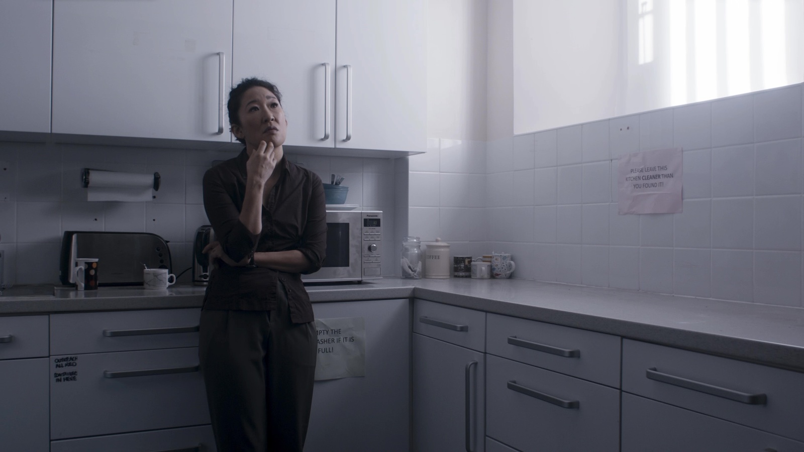 a woman standing in a kitchen