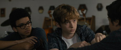 a group of young men sitting around a table