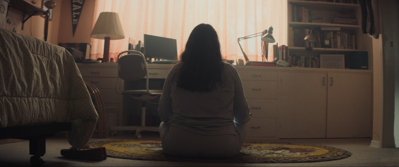 a woman sitting on a rug in a room