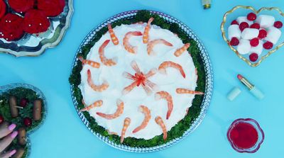 a table topped with a cake covered in shrimp