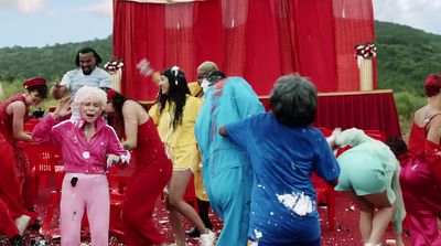 a group of people dressed in red and yellow dancing