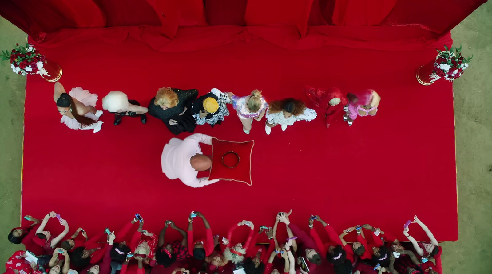 a group of people standing on top of a red carpet