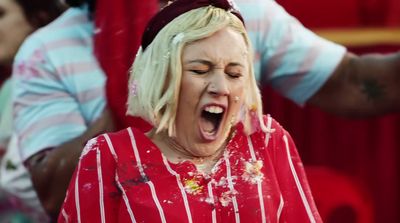 a woman in a red and white striped shirt with her mouth open