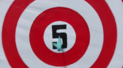 a red and white target with the number five on it