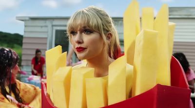 a woman in a costume made of cheese sticks