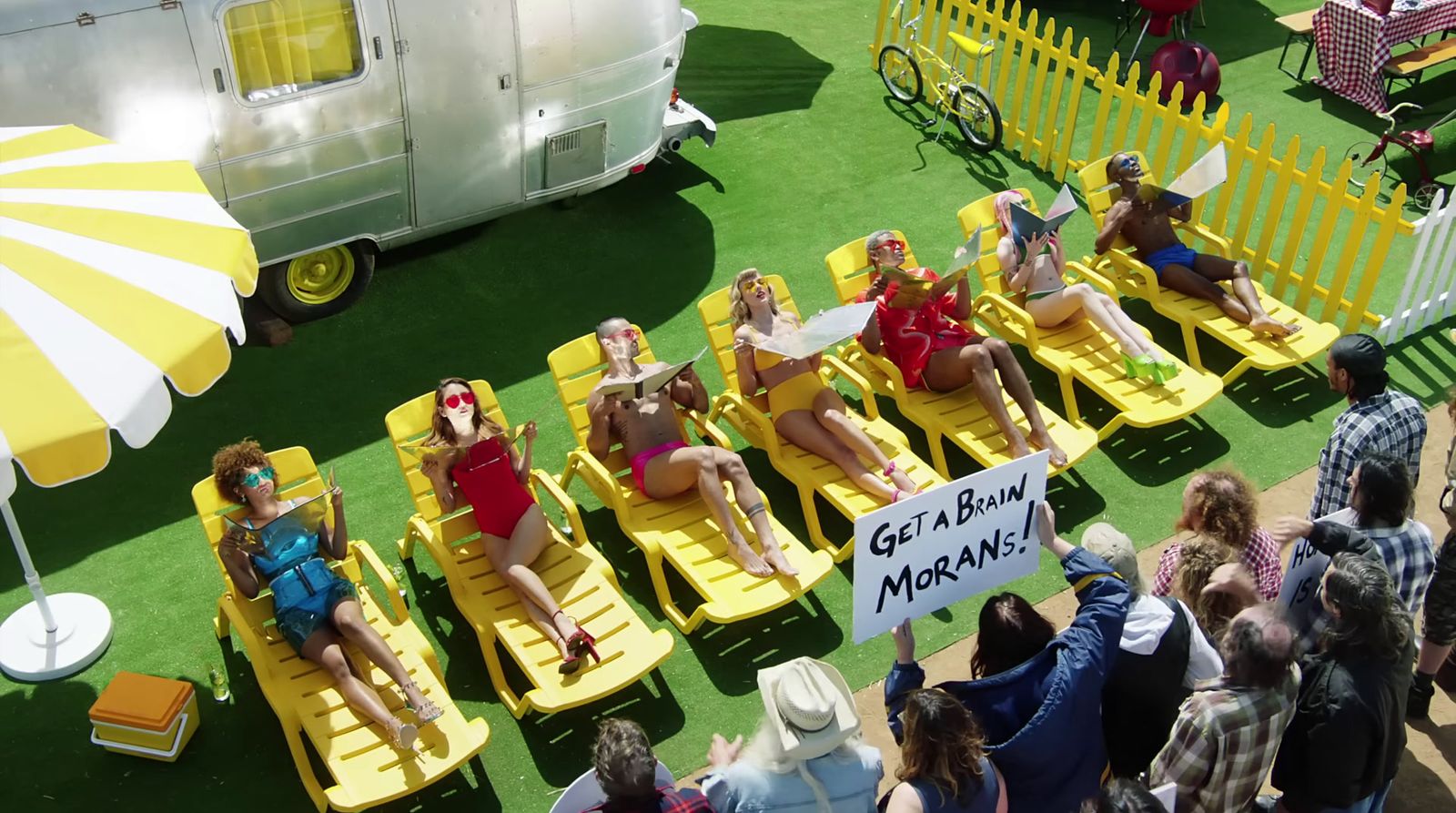 a group of women sitting on yellow lawn chairs