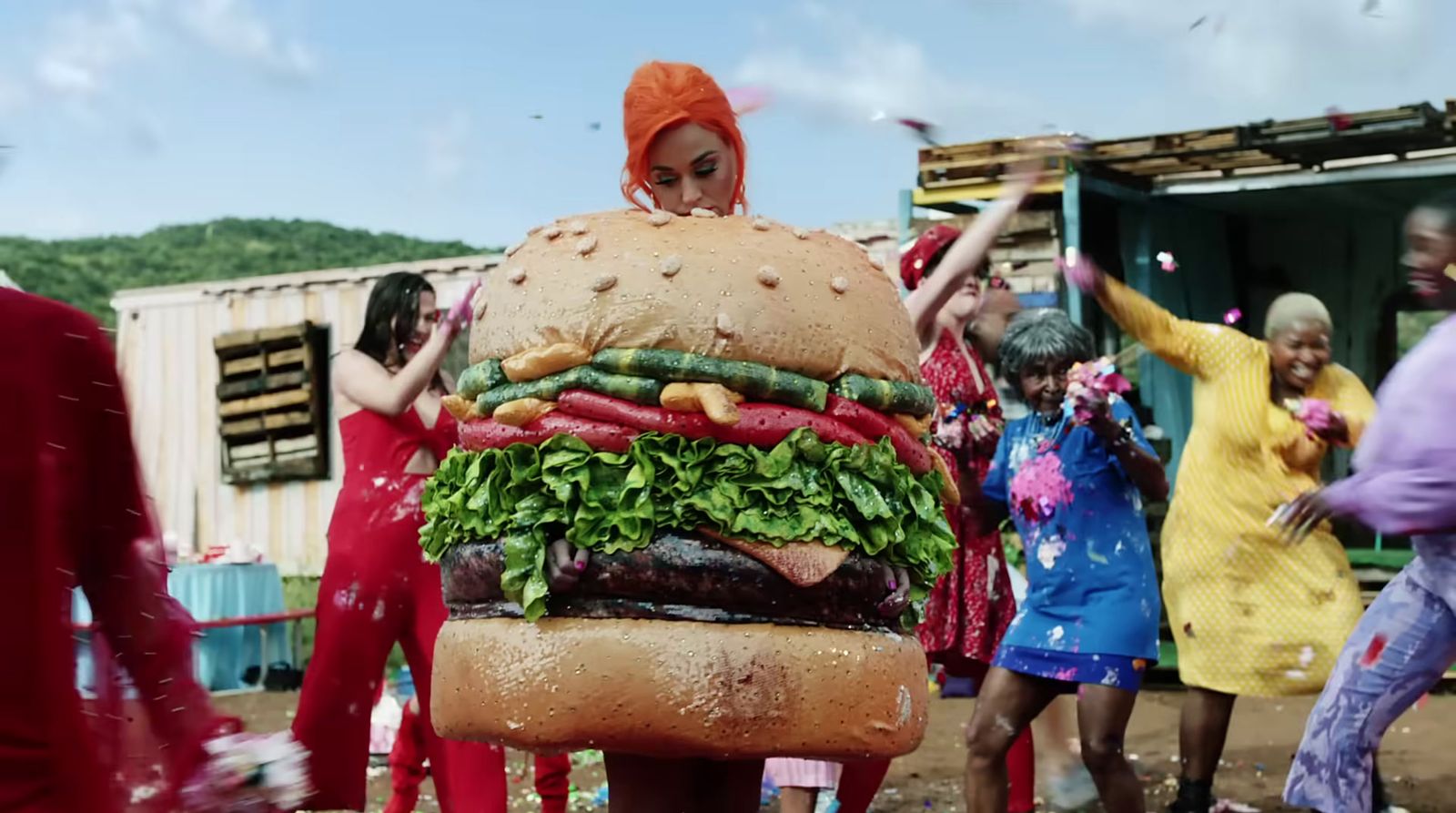 a giant hamburger made out of vegetables on a chair