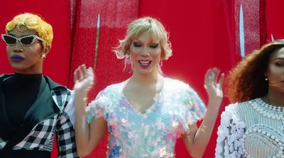 a group of three women standing next to each other