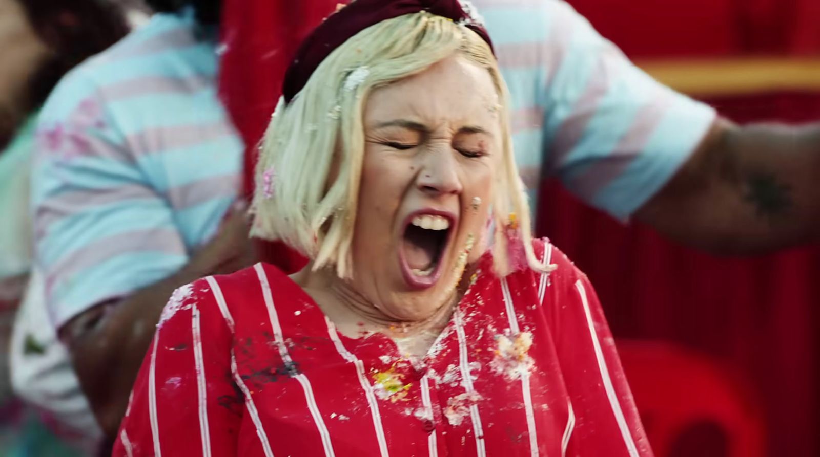 a woman in a red and white striped shirt with her mouth open