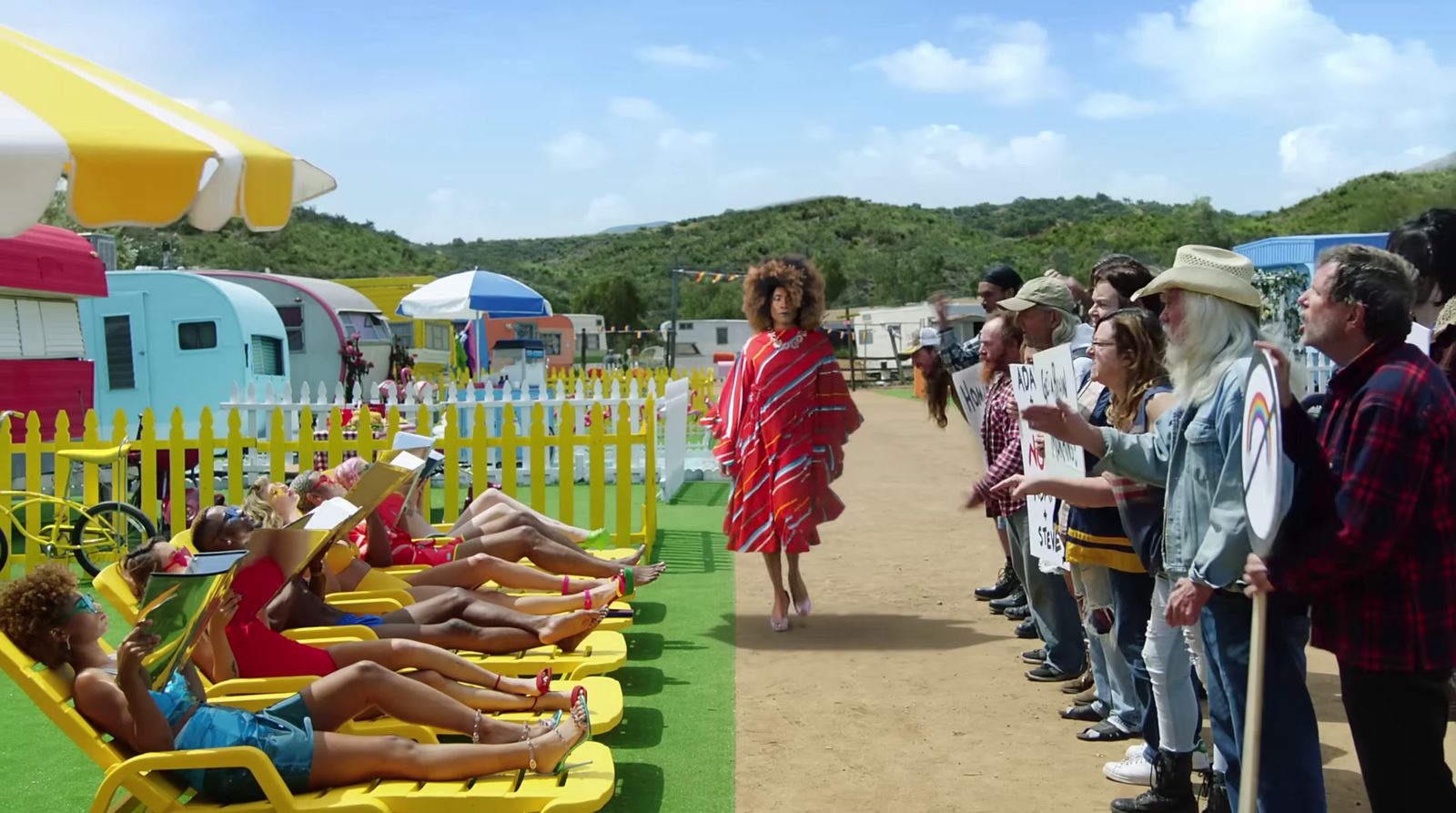 a group of people standing around a yellow lawn chair