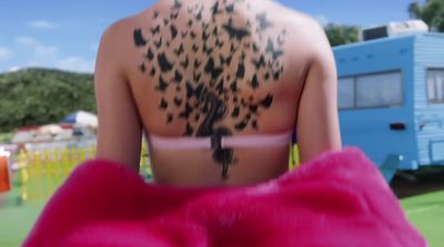 a woman with a bird tattoo on her back