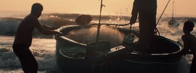 a group of people standing around a boat in the water