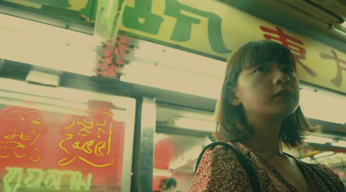 a woman standing in front of a store window