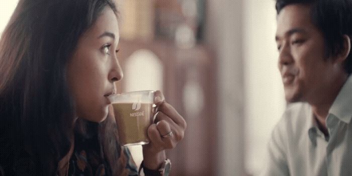 a man and a woman drinking coffee together