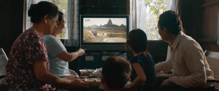 a group of people sitting in front of a tv