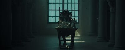 a dark room with a table and a window