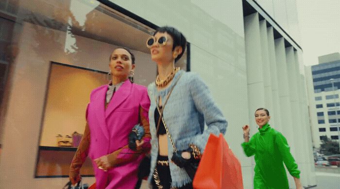 a couple of women walking down a street