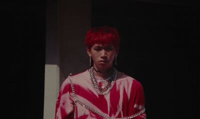 a man with red hair wearing a red and white shirt