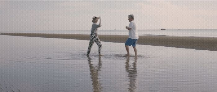 a couple of people that are standing in the water