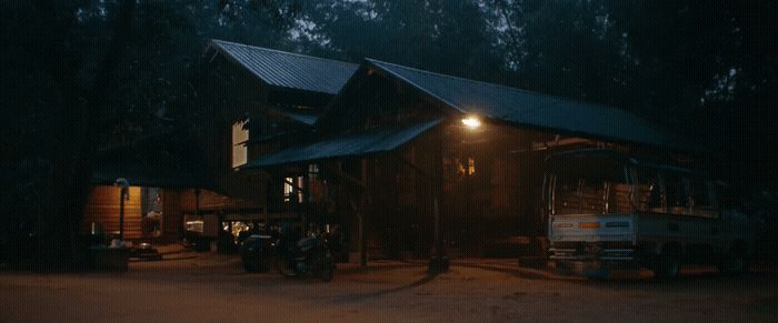 a truck is parked in front of a cabin