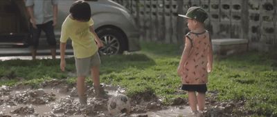 a couple of kids playing with a soccer ball