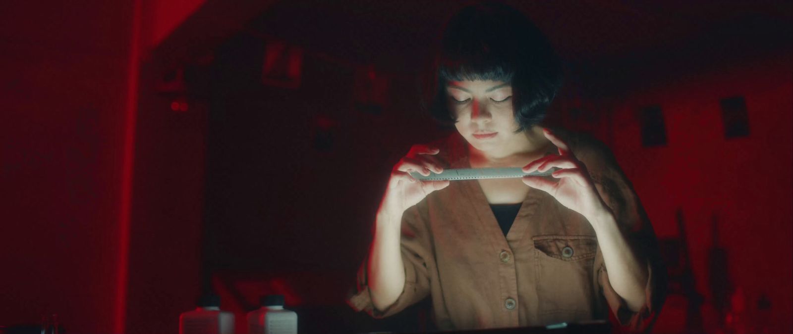 a woman holding a cell phone in a dark room