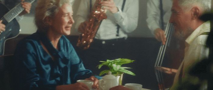 a group of people sitting around a table playing instruments