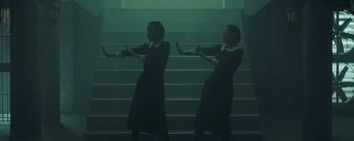 a couple of women standing on top of a set of stairs