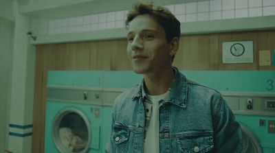 a man standing in front of a washing machine