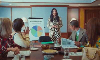 a woman giving a presentation to a group of people