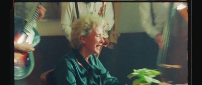 a woman sitting in a chair with a plant in front of her