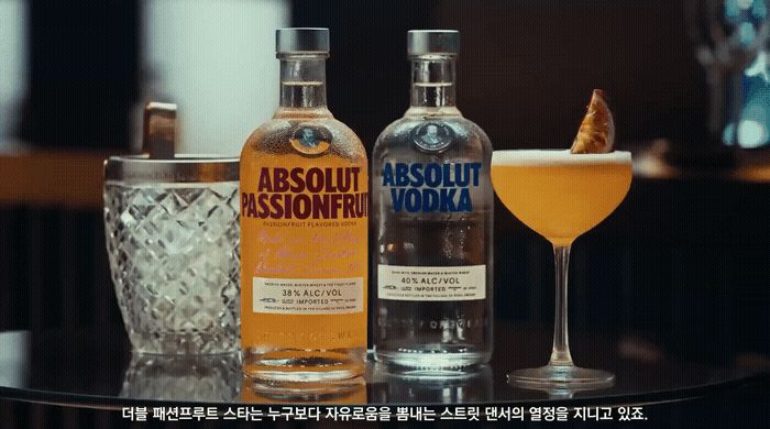 two bottles of absolut vodka sitting on a table