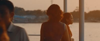 a group of people standing next to each other near a body of water