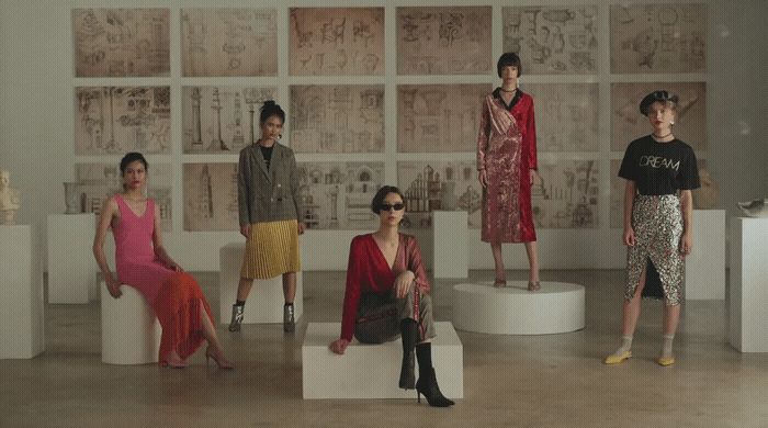 a group of women sitting on stools in a room