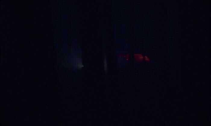 a blurry image of a red object in the dark