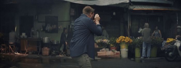 a man is taking a picture of himself in the street